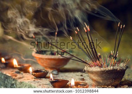 Burning aromatic incense sticks. Incense for praying Buddha or Hindu gods to show respect. Royalty-Free Stock Photo #1012398844