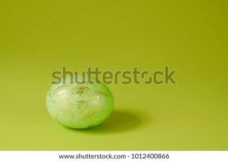 Minimalist concept Template with one easter egg on a green background
