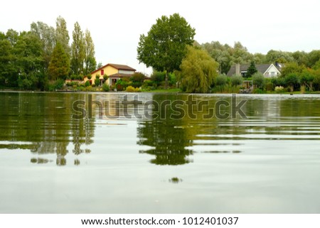 Reflection of green trees on water,  nature, countryside in Spijkenisse, Waterland, in South Holland