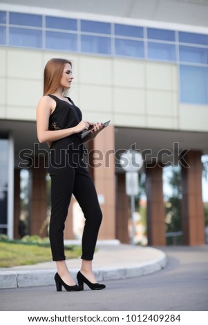 Girl with documents at a business meeting near a modern building