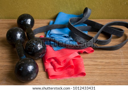 Sport equipment on the floor- dumbbells and resistance bands