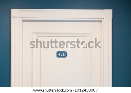 The door of room, House Number 410 sign