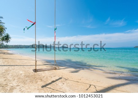 Swing hang from coconut palm tree over summer beach sea in Phuket ,Thailand. Summer, Travel, Vacation and Holiday concept 
