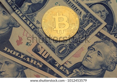 Bitcoins with US banknotes, golden bitcoin, silver bitcoin, bronze bitcoin. New virtual money.