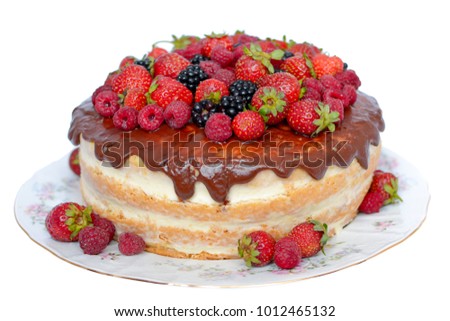 Cake in chocolate icing with fresh strawberries, raspberries and blackberry on white background. Close-up. Picture for a menu or a confectionery catalog.