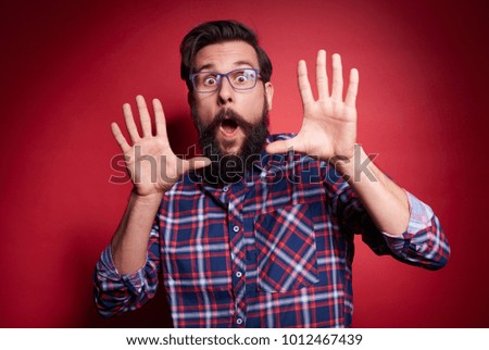 Terrified man gesturing at studio shot 