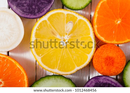 sliced fruits and vegetables on white wood table background