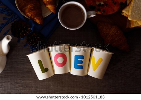 White glass with the word LOVE to put on a series of hot cocoa concept of love.