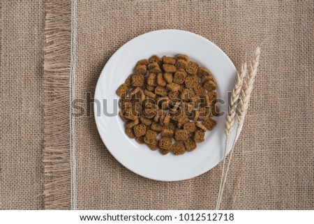 Bread rusks and croutons on a brown sackcloth surface.