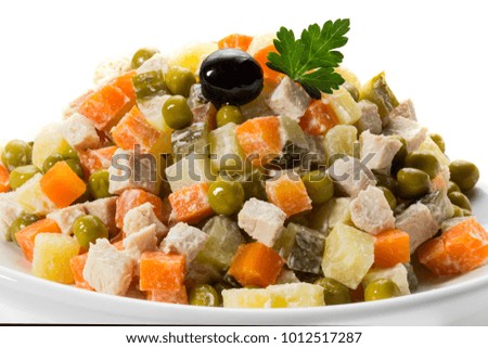 Russian salad with potato, meat, carrot, pickles and mayonnaise 