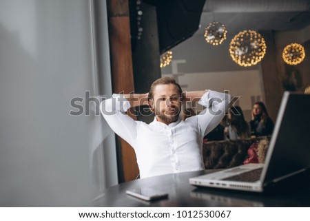 Business man working on computer in a cafe