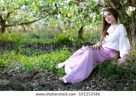 beauty young woman in the apple garden