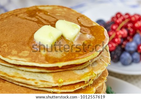 pancakes with melted butter and honey. Royalty-Free Stock Photo #1012557619