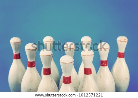 Vintage wooden bowling pins on a blue background