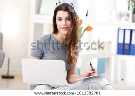 Picture showing young woman working in her home office
