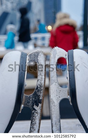 Ice skates with defocused people in the background
