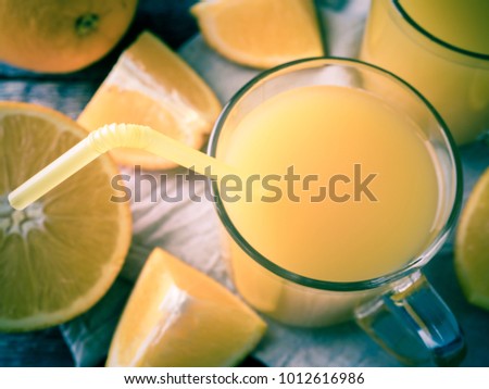 Fresh orange juice on wooden background, rustic style.