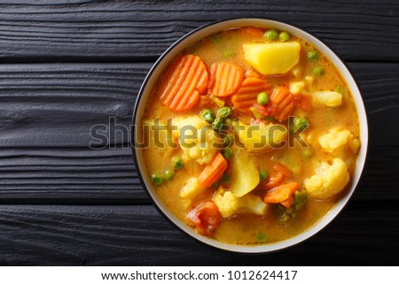 Vegetarian curry from vegetables with coconut milk close-up in a bowl on the table. horizontal top view from above
 Royalty-Free Stock Photo #1012624417
