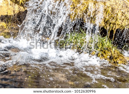 Small waterfall as autumn background