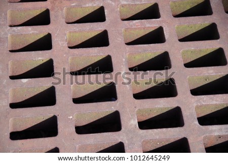 Rusted color street steel water drain grille closeup