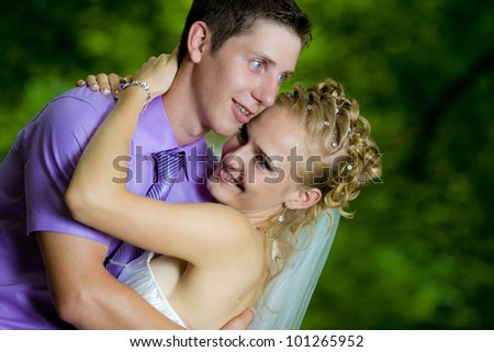 Bride and groom with a bouquet of looking at each other