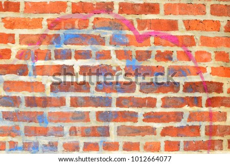 Red Brick Wall with Spray Paint