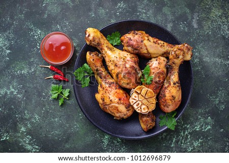 Grilled chicken legs with spices and garlic. Top view Royalty-Free Stock Photo #1012696879