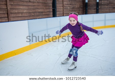 Happy girl skating on ice
