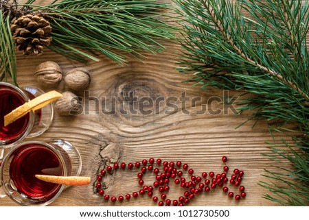 Mulled wine with spices on wooden background