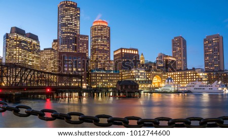 The architecture of the Boston Harbor and Financial District at night.
