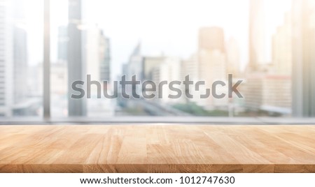 Empty wood table with blur room office and window city view background.For montage product display or design key visual layout. Royalty-Free Stock Photo #1012747630