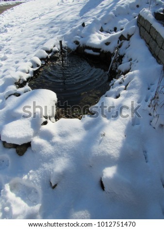 Man made pond after snowfall 