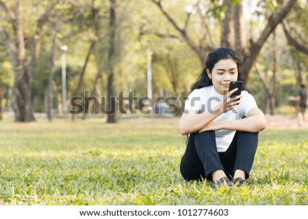 close up beauty asian woman in white shirt and use smartphone on blur background