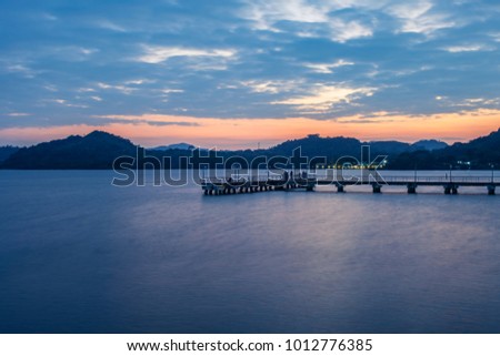 pier in a lake at sunset