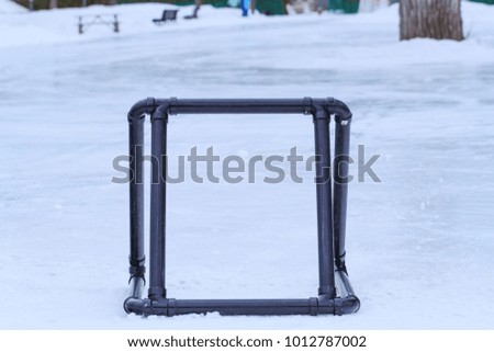 Ice skating support in a public ice rink. Winter background in playground. Equipment for outdoor activities in the winter.  Sport equipment in Canadian sport arena. Conceptual picture.