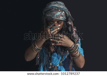 gypsy style young woman wearing tribal jewellery portrait Royalty-Free Stock Photo #1012789237
