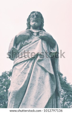 Jesus Christ the King Statue. Son of God with Sacred Heart art composition in details, fragment of antique statue.