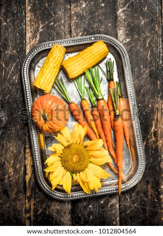Organic food. Fresh harvest of vegetables. On a wooden background.