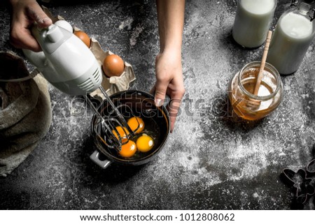 Dough background. A woman is preparing a fresh dough. On a rustic background.