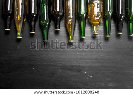 Bottles with fresh beer. On the black chalkboard.