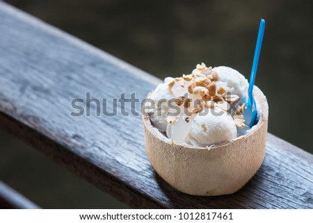 Coconut ice cream. Sweet coconut ice cream in the fresh coconut and plastic spoon. coconut ice cream is very popular dessert in market.Thailand
