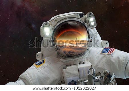 An astronaut watching the Solar Eclipse in space "Elements of this image furnished by NASA"
