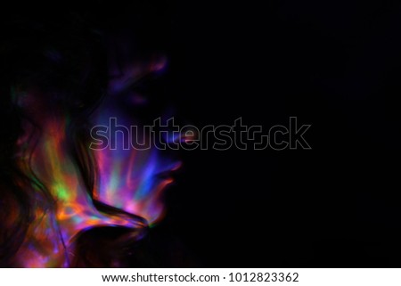 abstract portrait of young girl under colorful fluorescent Neon dark lights, enigmatic style