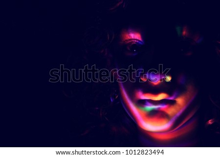 abstract portrait of young girl under colorful fluorescent Neon dark lights, enigmatic style