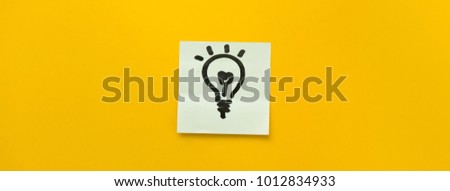 Hand drawn light bulb icon on sticky note paper representing ideas, creativity and innovation in colorful yellow banner background