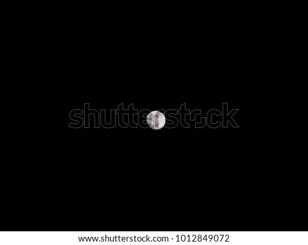 Beautiful and dramatic close up  photograph of a full waxing gibbous phase of the moon in the dark black night sky both intricate and detailed showing the lunar craters.