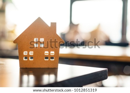 Concept of hard paper house on wood table , a symbol for construction , ecology, loan, mortgage, property or home.