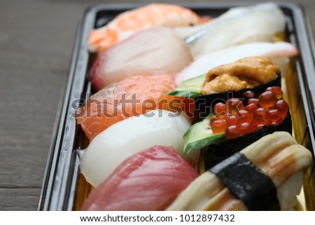 Nigirizushi sushi shaped by hand Royalty-Free Stock Photo #1012897432