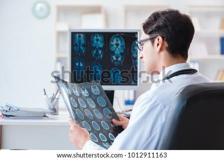 Doctor radiologist looking at x-ray images Royalty-Free Stock Photo #1012911163