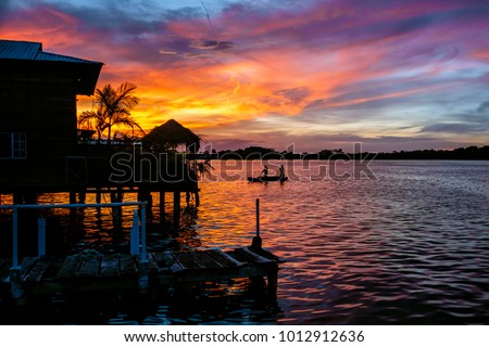 Sunset seen from a pier in Bocas del Toro, Panama. Royalty-Free Stock Photo #1012912636